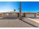 Ranch style home with two car garage and palm trees at 11009 W Crestbrook Dr, Sun City, AZ 85351