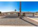 Single story home with a two-car garage, and desert landscaping at 11009 W Crestbrook Dr, Sun City, AZ 85351