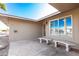 Covered porch with stone benches and a security door at 11009 W Crestbrook Dr, Sun City, AZ 85351