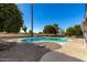 Inviting kidney shaped pool surrounded by gravel and lush landscaping at 11009 W Crestbrook Dr, Sun City, AZ 85351