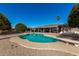 Relaxing kidney-shaped pool with diving board and patio furniture at 11009 W Crestbrook Dr, Sun City, AZ 85351