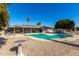 Stunning kidney-shaped pool with patio furniture and a bird bath at 11009 W Crestbrook Dr, Sun City, AZ 85351