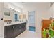 Well-lit bathroom with a double sink vanity and a view into the toilet and shower area at 11802 S Half Moon Dr, Phoenix, AZ 85044