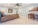 Bright bedroom featuring a ceiling fan, writing desk, and a comfortable bed with throw pillows at 11802 S Half Moon Dr, Phoenix, AZ 85044