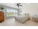 Serene bedroom with a large window, light blue walls, and a comfortable bed with decorative pillows at 11802 S Half Moon Dr, Phoenix, AZ 85044