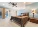 Comfortable bedroom with a ceiling fan, bedside table, and sliding glass door to the outside at 11802 S Half Moon Dr, Phoenix, AZ 85044