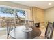 Cozy dining area with brick fireplace and large windows showcasing outdoor views at 11802 S Half Moon Dr, Phoenix, AZ 85044