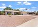 Single-story home with a two-car garage featuring desert landscaping for low maintenance at 11802 S Half Moon Dr, Phoenix, AZ 85044