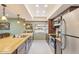 Kitchen featuring wood cabinets, stainless steel appliances, and tile floors at 11802 S Half Moon Dr, Phoenix, AZ 85044