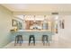 Charming kitchen with wooden cabinets, stainless steel appliances, pendant lighting, and bar seating at 11802 S Half Moon Dr, Phoenix, AZ 85044