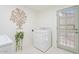 Bright laundry room features a new washer, tree wall decor, and stylish door at 11802 S Half Moon Dr, Phoenix, AZ 85044