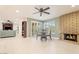 Open-concept living area featuring tile floors, a decorative fireplace, and sliding doors leading to the backyard at 11802 S Half Moon Dr, Phoenix, AZ 85044