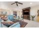 Bright and spacious living room with a ceiling fan, tile floors, and a view of the dining area at 11802 S Half Moon Dr, Phoenix, AZ 85044