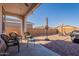 Covered patio with wicker furniture, umbrella, and brick pavers at 12246 E Pivot Peak E --, Gold Canyon, AZ 85118