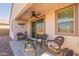 Relaxing covered patio with wicker chairs and glass-top table at 12246 E Pivot Peak E --, Gold Canyon, AZ 85118