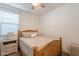 Bright bedroom with wood bed frame and ceiling fan at 12246 E Pivot Peak E --, Gold Canyon, AZ 85118