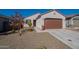 Single-story home with a two-car garage and desert landscaping at 12246 E Pivot Peak E --, Gold Canyon, AZ 85118