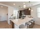 Bright kitchen boasts an L-shaped island and white quartz countertops at 12246 E Pivot Peak E --, Gold Canyon, AZ 85118