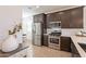 Modern kitchen with dark wood cabinets and stainless steel appliances at 12246 E Pivot Peak E --, Gold Canyon, AZ 85118