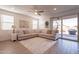 Living room with L-shaped sofa, access to backyard, and ceiling fan at 12246 E Pivot Peak E --, Gold Canyon, AZ 85118