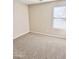 Carpeted bedroom with neutral walls and a window with blinds at 12367 W Woodland Ave, Avondale, AZ 85323