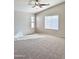 Spacious bedroom with ceiling fan and neutral carpet at 12367 W Woodland Ave, Avondale, AZ 85323