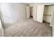 Bright bedroom featuring carpeted floors and a large closet at 12367 W Woodland Ave, Avondale, AZ 85323