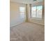 Spacious bedroom with large windows, carpet flooring, and neutral walls at 12367 W Woodland Ave, Avondale, AZ 85323