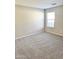 Spacious bedroom with neutral carpeting and large window at 12367 W Woodland Ave, Avondale, AZ 85323