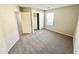 Bright bedroom with neutral walls, carpet flooring, and a double door closet at 12367 W Woodland Ave, Avondale, AZ 85323