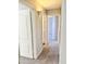 Well-lit hallway featuring carpeted floors and neutral walls at 12367 W Woodland Ave, Avondale, AZ 85323