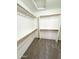 Large walk-in closet with double hanging rods and shelving at 12367 W Woodland Ave, Avondale, AZ 85323