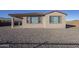 Backyard view of the home, showing gravel and fencing at 12474 E Soloman Rd, Gold Canyon, AZ 85118