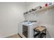 Bright laundry room featuring washer, dryer, and shelving at 12474 E Soloman Rd, Gold Canyon, AZ 85118