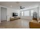 Living room features wood-look tile, ceiling fan, and large TV at 12474 E Soloman Rd, Gold Canyon, AZ 85118