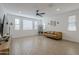 Living room with light walls, wood-look tile, and a tan couch at 12474 E Soloman Rd, Gold Canyon, AZ 85118