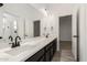 Double vanity bathroom with dark cabinetry and a large mirror at 12808 N 144Th Dr, Surprise, AZ 85379