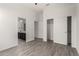 Well-lit bedroom with wood-look floors and a large closet at 12808 N 144Th Dr, Surprise, AZ 85379