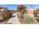 Attractive community entrance with a brick column and landscaped walkway at 12808 N 144Th Dr, Surprise, AZ 85379