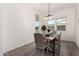 Bright dining room with wood-look floors and modern chandelier at 12808 N 144Th Dr, Surprise, AZ 85379