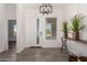 Bright entryway with wood-look tile flooring and modern light fixture at 12808 N 144Th Dr, Surprise, AZ 85379