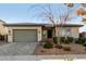 Single-story home with a two-car garage and landscaped front yard at 12808 N 144Th Dr, Surprise, AZ 85379