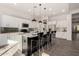 Modern kitchen with white cabinets, large island, and stainless steel appliances at 12808 N 144Th Dr, Surprise, AZ 85379