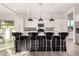 Modern kitchen with a large center island and black pendant lights at 12808 N 144Th Dr, Surprise, AZ 85379