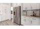 Kitchen with stainless steel refrigerator and white cabinets at 12808 N 144Th Dr, Surprise, AZ 85379