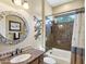 Charming bathroom with a bathtub, shower, and decorative mirror at 12975 W Andrew Ln, Peoria, AZ 85383