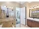 Elegant bathroom with a walk-in shower, vanity, and large mirror at 12975 W Andrew Ln, Peoria, AZ 85383