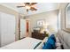 Bright bedroom featuring a queen bed, dresser, and window with shutters at 12975 W Andrew Ln, Peoria, AZ 85383