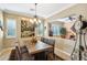 Elegant dining room with a rustic wooden table, chandelier, and views into adjacent rooms at 12975 W Andrew Ln, Peoria, AZ 85383