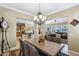 Bright dining room with a large wooden table and access to the kitchen and living areas at 12975 W Andrew Ln, Peoria, AZ 85383